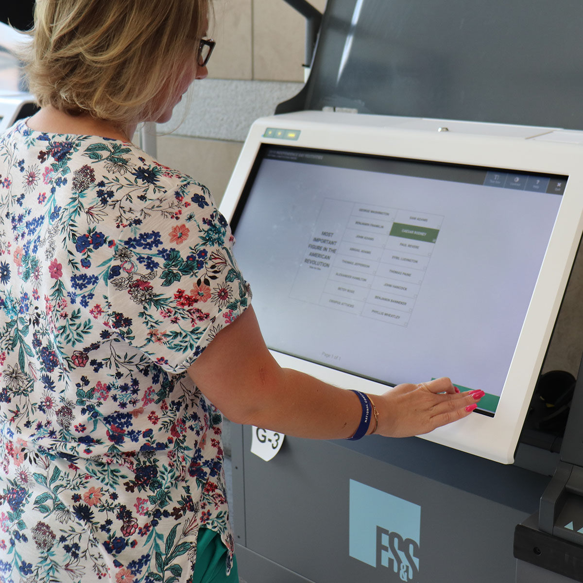 A woman voting using an ExpressVote XL