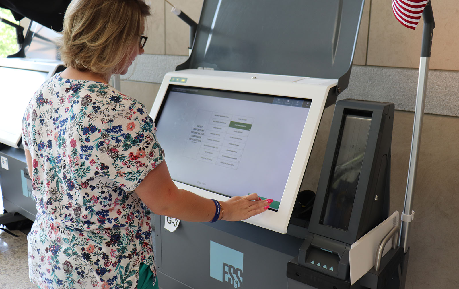 A woman voting using an ExpressVote XL