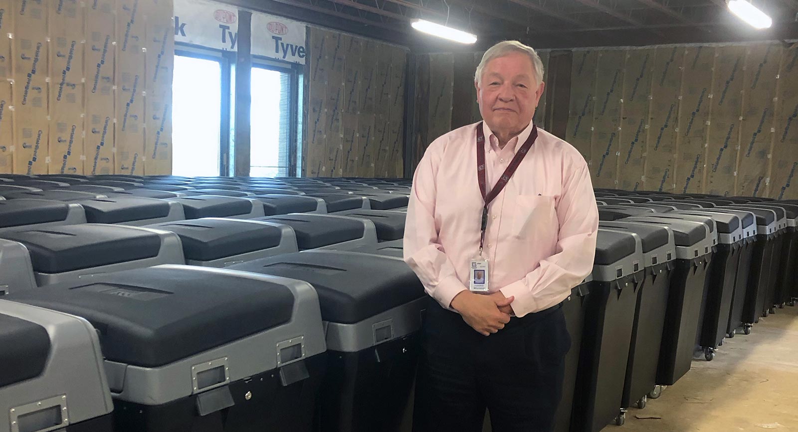 Conway Belangia, Greenville County's Director of Voter Registration and Elections with rows of locked DS200 units.