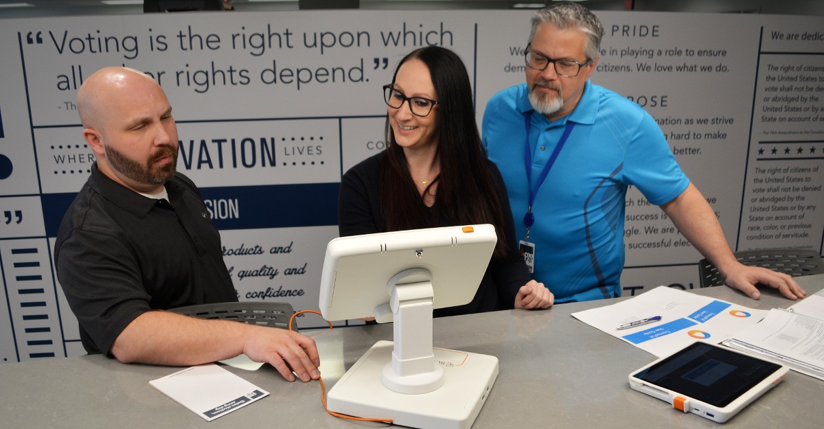 Members of the pollbook team meet to review the user guide.