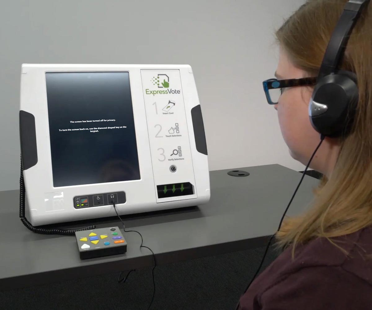 An ExpressVote with the screen hidden while the voter listens to audio prompts to navigate the voting process.