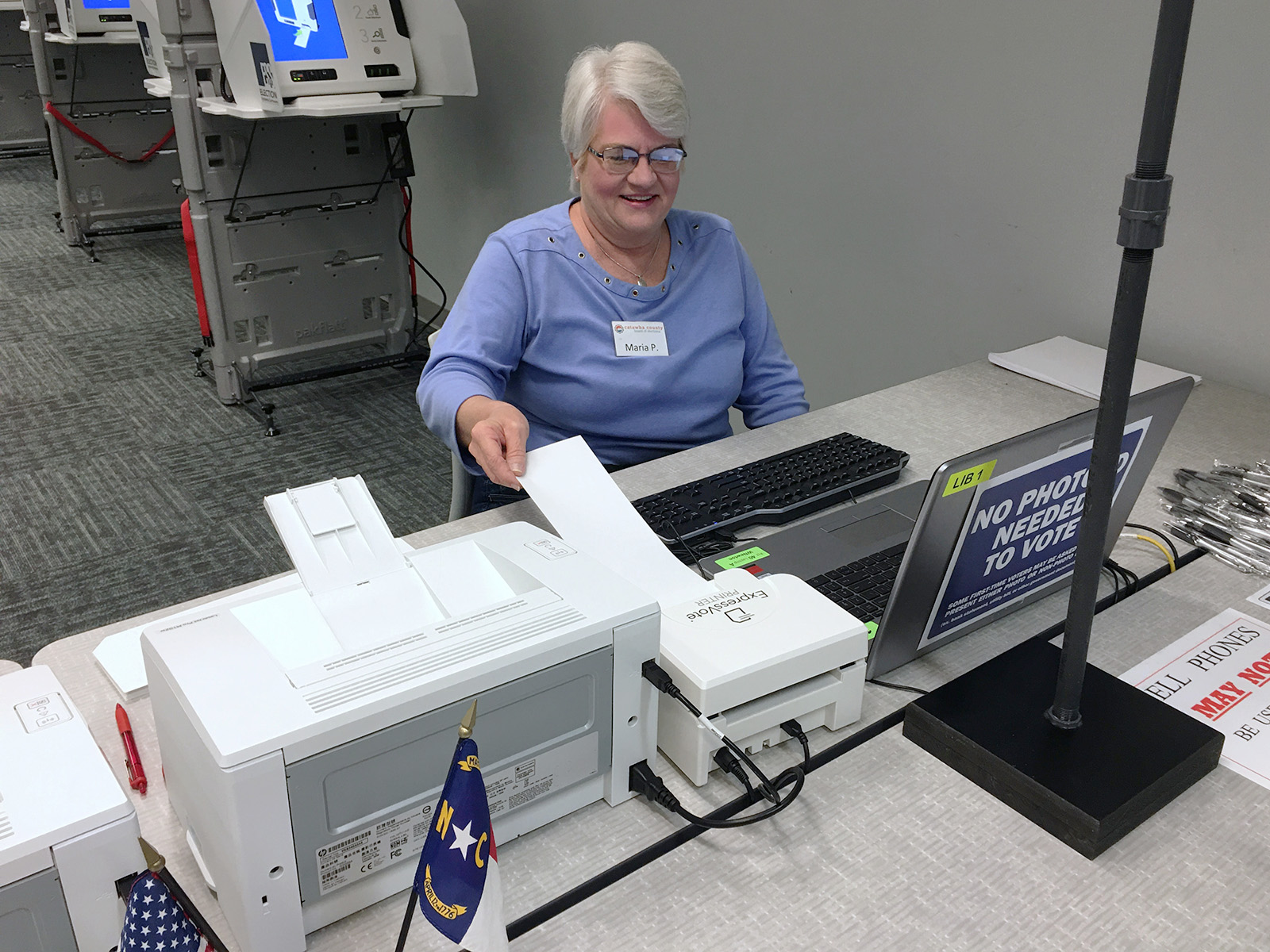 A Catawba County poll worker puts a blank ballot in the ExpressVote Printer, which prints a voter’s precinct number and ballot style barcode on the ballot.