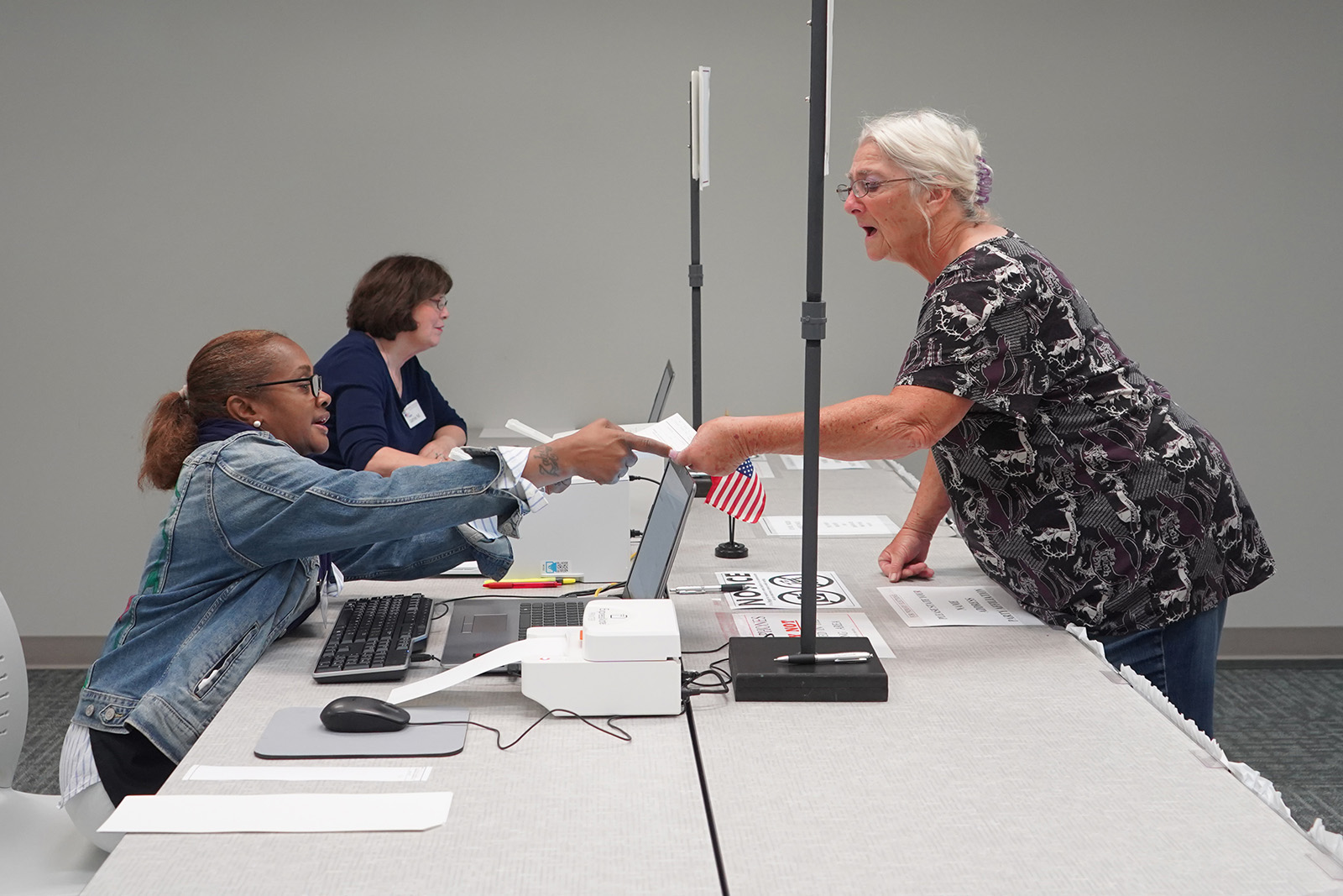 A Catawba County, NC voter receives the state-required absentee voting application as the first step to checking in for early voting during the 2021 primary election.