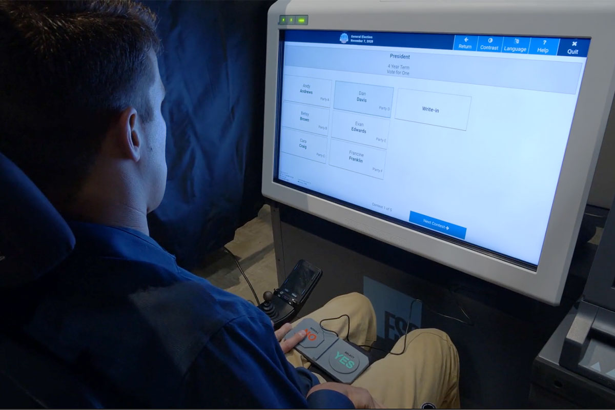 Universal Voting - ExpressVote XL with Rocker Switch A voter making selections on ExpressVote XL using a two-position rocker switch