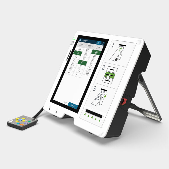An ExpressVote unit with vote selections displayed on screen, with an audio-tactile keypad connected to the unit.