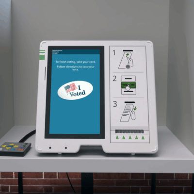 An ExpressVote 3 universal voting system, with audio-tactile keypad, placed in a voting booth